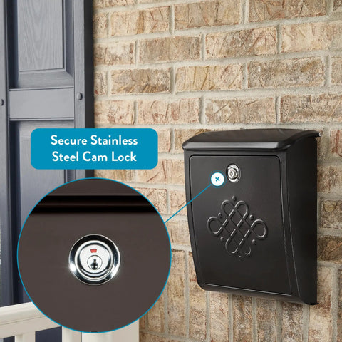 Locking Wall-Mounted Mailbox in Rubbed Bronze with decorative embossed design and secure cam lock, mounted on brick wall.