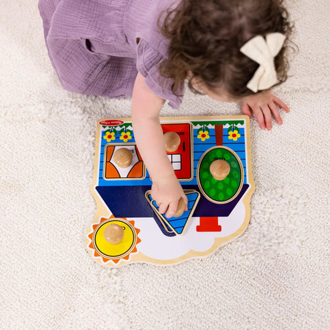 Toddler playing with First Shapes Jumbo Knob Puzzle For Toddlers With Wooden Peg Pieces, focusing on shape matching activities