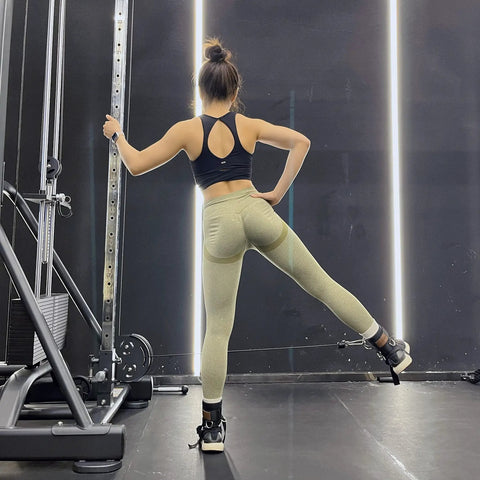 Woman using Secure Fit Two Pack Ankle Straps For Cable Machine With Crazy Comfy Neoprene Padding and Bombproof Steel Double Hooks.