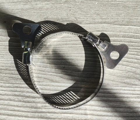 Close-up of a single clamp from the 16-Piece 304 Stainless Steel Hose Clamps Set with Adjustable Thumbscrews on a wooden surface.