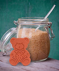 Two Pack Terracotta Brown Sugar Saver And Softener Keeps Brown Sugar Moist For Months in bear shape next to sugar jar.