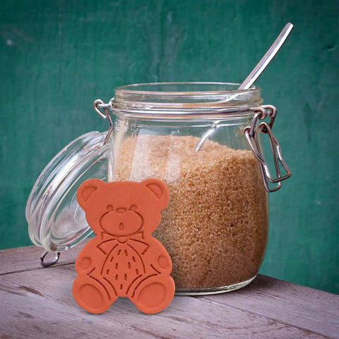 Two Pack Terracotta Brown Sugar Saver And Softener Keeps Brown Sugar Moist For Months in bear shape next to sugar jar.