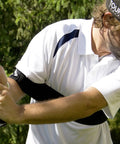 Golfer using Groove Your Golf Swing Path With This Easy Full Swing Trainer For Wedges And Short Irons, Improves Form, Prevents Flying Elbow Takeaway, Builds Consistency, Ideal Practice Tool For Home Or Range, Small Size on outdoor course.
