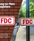 Heavy Duty 6X12 Inch Fire Department Connection FDC Sign With 3M Engineer Grade Reflective Film mounted on a pole and wall.