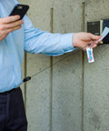 Person using Sidekick ID Badge And Key Reel With 24 Inch Kevlar Cord, Tough Polycarbonate Case, Zinc Alloy Carabiner at access point.