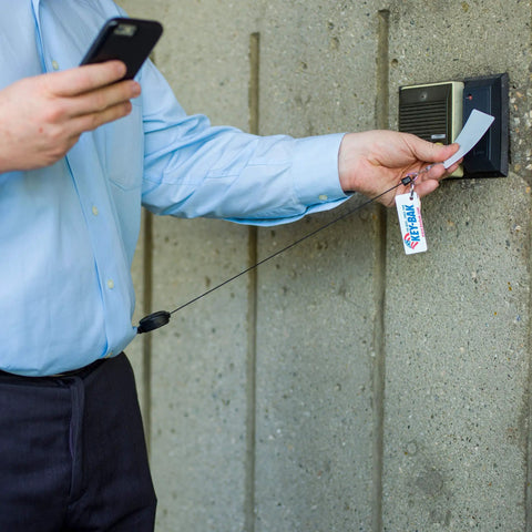 Person using Sidekick ID Badge And Key Reel With 24 Inch Kevlar Cord, Tough Polycarbonate Case, Zinc Alloy Carabiner at access point.