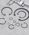 Internal Retaining Ring Circlip Set Two Pack, various sizes, with caliper on gray background, 65Mn steel, black oxide finish.