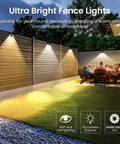 Solid Solar Fence Lights For Outdoor Deck Railings And Garden Pathways Featuring Smooth Color Changing RGB Cycles With IP65 Waterproof Design Great To Level Up Your Backyard Hangout And Serve Dope Nighttime Ambiance In An Eight Piece Set, illuminating a landscaped area with soft lighting.
