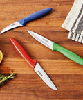 Three Piece Peeling And Paring Knife Set With Covers For Easy Fruit And Veg Prep, Includes Bird's Beak Knife, Serrated Paring Knife, And Straight Edge Paring Knife In Blue Green And Red, A Kitchen Essential For Every Home Cook on wooden surface