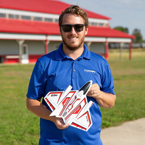 Person holding an Ultra Micro RC Plane With Dope Twin Brushless Motors And Delta Wing BNF Basic Electric outdoors.
