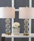 Clear Glass Triple-Sphere Table Lamps Set Of 2 With Brass Accents And White Linen Shade 27-Inch Tall displayed on a table