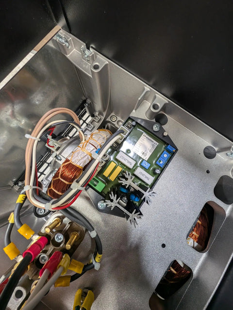 Internal view of Top Shelf Pto Generator With Auto Voltage Regulator and 16 Kw Continuous Power showcasing copper coils and wiring.