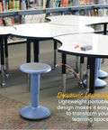 Powder blue SitWell Wobble Stool with adjustable height in classroom setting near tables and bookshelves.