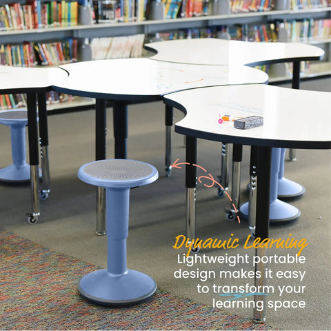 Powder blue SitWell Wobble Stool with adjustable height in classroom setting near tables and bookshelves.