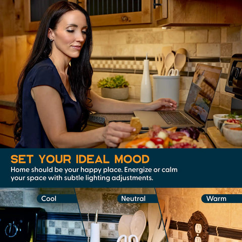 Woman in kitchen with laptop and Under Cabinet LED Light Kit For Kitchen With Motion Sensor 3 Light Strips visible above counter.