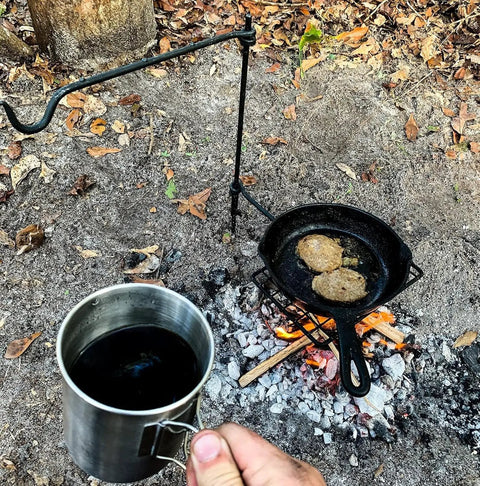 Swivel Grill Set For Campfire Cooking In The Great Outdoors Heavy Duty Steel Bushcraft Grate with coffee mug and skillet