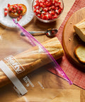 Jumbo 2.5 Gallon Storage Bags With Secure Zip And Click Closure Writable Label holding a baguette on a kitchen table.