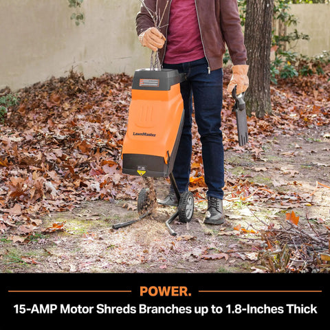 Person using FD1503 Electric Wood Chipper Shredder 15 Amp Motor With 1.8 Inch Cutting Diameter And 14 To 1 Reduction