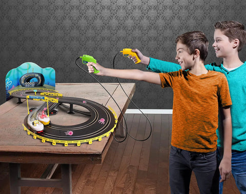 Boys playing with Eight Feet Of Track SpongeBob Hot Rod Boat Slot Car Race Set With Dual Player Racing Lap Counter Three Track Layouts