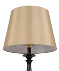 Close-up of light gold tapered drum shade from Gavin Lamp Set Duo In Golden Flecked Bronze With Gold Highlights lamp.