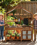 Children playing with Outdoor Mud Kitchen For Kids With Canopy Wooden Pretend Play Kitchen Chalkboard Four Stoves Removable Sink