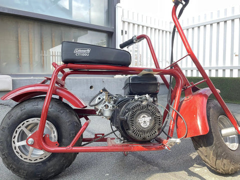 Red Coleman CT100U mini bike with large tires and visible engine, suitable for 180mm Mini Bike Disc Brake Rotor With Pads Replacement.