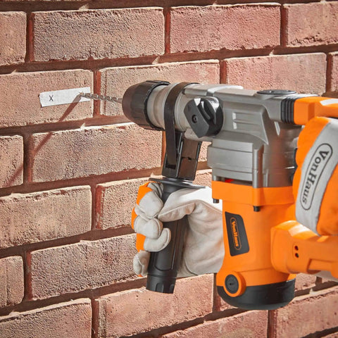 10 Amp Rotary Hammer Drill With Vibration Control Three Modes Demolition Kit in use on brick wall, showing drilling mode