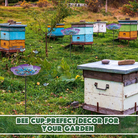 Beehives surrounded by Vivid Flower Bee Watering Station With Metal Butterfly Water Feeder Cup and 30 glass marbles in a garden