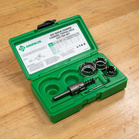 Four Piece Quick Change Carbide Tipped Hole Cutter Set Delivers Fast Precise Holes From Seven Eighths To One And Three Eighths Inches In Stainless Steel Mild Steel Copper And Aluminum With Quick Change Arbor displayed in green case