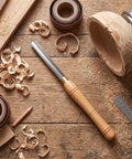 Workhorse HSS Woodturning Bowl Gouge And Spindle Gouge For Wood Lathes, high speed steel chisel on woodworking bench with shavings.
