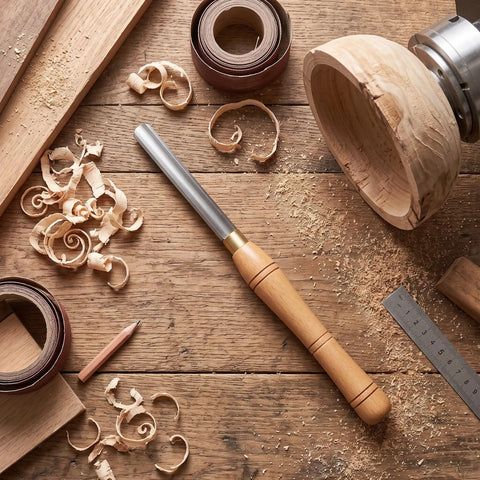 Workhorse HSS Woodturning Bowl Gouge And Spindle Gouge For Wood Lathes, high speed steel chisel on woodworking bench with shavings.