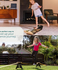Child balancing on Backyard Slackline Kit Freestanding Slackline System For Kids And Adults, Adjustable Outdoor Balance Trainer.