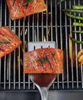 Precision 3 Piece Grilling Tool Set With Stainless Steel Tongs Spatula And Silicone Basting Brush Non Slip Handles Hands Free Locking For Easy Flip And Pro Level Cookout Ready Grilling Gear lifting grilled salmon on barbecue