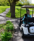 9 Gallon UTV And ATV Spot Sprayer With Everflo 1.0 GPM Diaphragm Pump mounted on a golf cart driving through a park.
