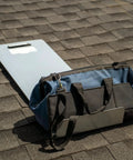 Badass 16 Gauge Pre Galvanized Steel Roofing Shingle Tray 40 By 14 5 Inches resting on shingles next to a tool bag.