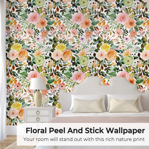 Colorful flower pattern on wall using Peel And Stick Floral Boho Textured Wallpaper For Bedroom And Bathroom Waterproof Removable Renter Friendly Pink Watercolor Modern Look With A Chic Vibe For Kitchen Cabinets 17.5 By 118 Inches behind a bed with white pillows and a white bedside table with a lamp.