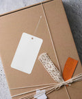 White PVC Blank Hanging Tags With Lanyard 100pcs waterproof on brown box with lace and orange paper