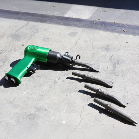 Short Barrel Air Hammer Kit With Four Chisels, One And Five Eighths Inch Stroke, 4500 BPM, 4 CFM At 90 PSI on concrete surface