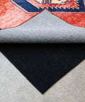 Nonskid Rug Pad 3' x 5' Plush Reversible Gripper One Quarter Inch Thick under a red area rug on a concrete floor.