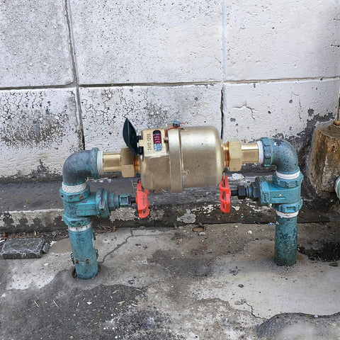 Installed Three Quarter Inch Non Pulsed Rotary Piston Water Meter with heavy duty brass construction for industrial cold water systems.