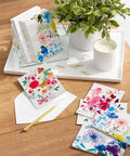 Assorted Blank Greeting Cards With Painted Flower Designs, 48 Cards And Envelopes, 4 Styles, displayed with plant and pen