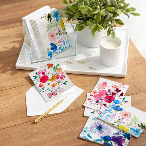 Assorted Blank Greeting Cards With Painted Flower Designs, 48 Cards And Envelopes, 4 Styles, displayed with plant and pen