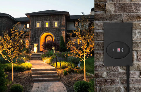 Nighttime view of a house with low voltage outdoor lighting transformer with photocell and timer, 120W 12V output, mounted on brick.