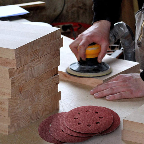 Person using orbital sander with 100 Pack Five Inch Eight Hole Sanding Discs Grit From 60 To 2000 For Wood Metal Paint Auto