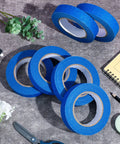 Blue Painters Tape Bulk 72 Rolls 1 Inch Wide By 55 Yards Each No Residue Masking Tape arranged with decor items on a table