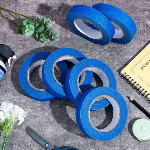 Blue Painters Tape Bulk 72 Rolls 1 Inch Wide By 55 Yards Each No Residue Masking Tape arranged with decor items on a table