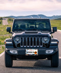 Jeep with Abalone Shell License Plate Frame Made From Stainless Steel For Front And Rear Car Tags With Screws Durable 6.3 By 12.2 Inches Adds Unique Style To Your Ride For Women And Men A Fun Car Decoration Accessory on a scenic road.