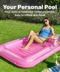 Woman in blue swimsuit relaxing on Inflatable Tanning Pool Lounger With Pillow 70 By 46 Inches Personal Water Filled Float in backyard.