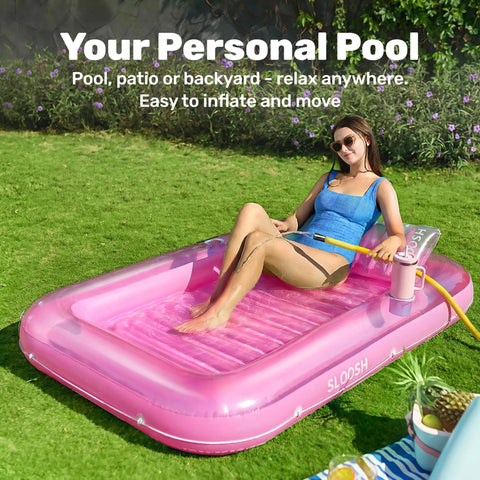 Woman in blue swimsuit relaxing on Inflatable Tanning Pool Lounger With Pillow 70 By 46 Inches Personal Water Filled Float in backyard.