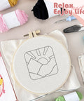 Easy To Use Punch Needle Coaster Kit For Beginners with tools, fabric, and yarn, showcasing landscape pattern in hoop